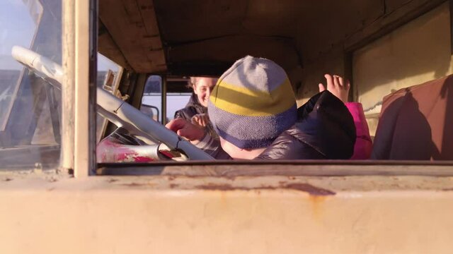 Children in old truck in village