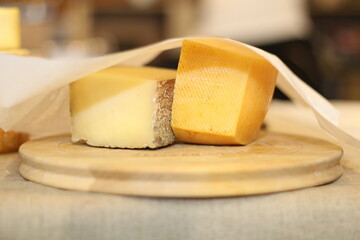 Business. Cheese on wood plate. Plate with different kind of cheese. Food photography. Market