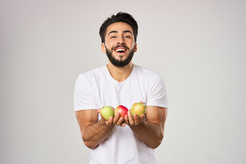 bearded man in white t-shirt apples holding healthy food