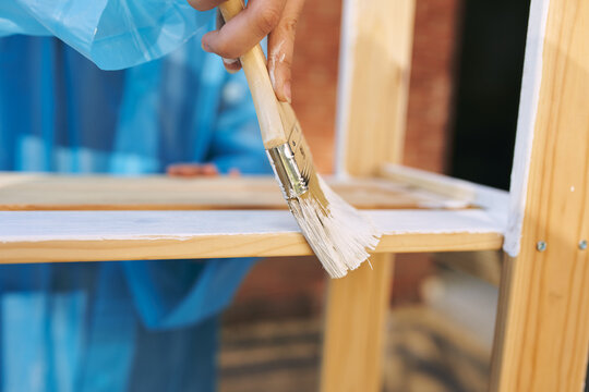 painter with brush paint wood interior design