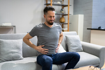 Man Suffering From Stomach Ache Sitting