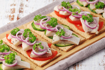 Sandwiches with herring and vegetables