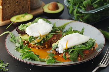 Homemade sandwiches with salmon, avocado and poached eggs