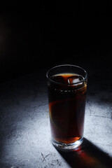 A glass with cola with ice