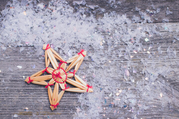 christmas hay decoration star shaped on wooden background with copy space