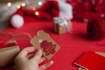 Merry chrsitmas paper tag with christmas tree on red background