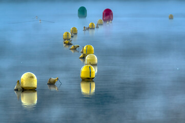 Nautical signaling buoys over the lake Orta waters (Piedmont, Northern Italy)  small lake of alpine origin, is UNESCO Site and home of a cloistered nuns convent. © stefanopez