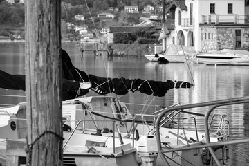 Fototapeta na wymiar Leisure boats moored on a pier of the Lake Orta, small lake of alpine origin in the Piedmont Region, Northern Italy. It has a little island (UNESCO Site) home of a cloistered nuns convent.