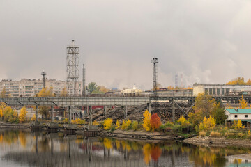 The infrastructure of a woodworking plant against the backdrop of an autumn landscape. Transport concept.