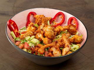 plated salad on colorful plate on wood