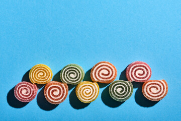 Fototapeta na wymiar Round marmalade candies on a blue background.