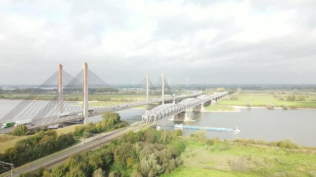 Dr. W. Hupkesbrug and Martinus Nijhoffbrug aerial drone view highway infrastructure bridge over a large waterway in The Netherlands. Zaltbommel