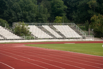 Athletic track red surface with white lines closeup