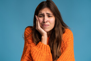 Dental problems. Portrait of unhealthy woman pressing sore cheek, suffering acute toothache,...