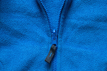 fleece blue sports jacket, artificial fabric as background, fleece sweaters background, tire soft warm fabric © Виктория Котлярчук