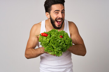 bearded man in white t-shirt lettuce leaf vegetables healthy food