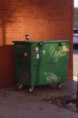 garbage on the street with graffiti