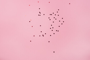 Valentine's Day background heart shaped confetti over pink background Minimal