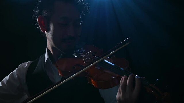Video of image of cool bearded male violinist.
