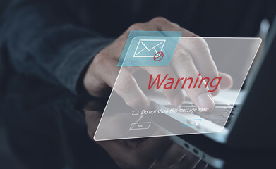Blocking spam e-mail, warning pop-up for phishing mail, network security concept. Business man working on laptop computer at home with warning window - obrazy, fototapety, plakaty