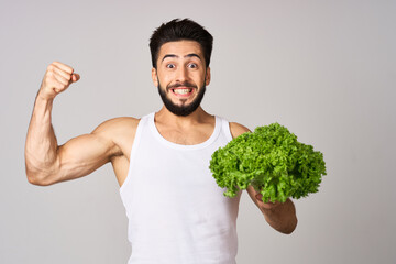 bearded man in white t-shirt lettuce leaf vegetables healthy food