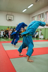 Two judo fighters showing technical skill while practicing martial arts in a fight club. The two fit men in uniform. fight, karate, training, arts, athlete, competition concept.Selective Focus