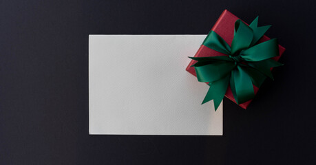 close up top view on blank white paper with christmas gift box on blank color background for design as greeting card, cyber Monday and blank friday promotional marketing ads concept