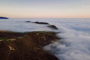 Fototapeta na wymiar Aerial view with fog or clouds and mountains. Foggy landscape