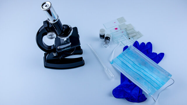 Laboratory Microscope With Samples Of Viruses On Glass, On A White Background