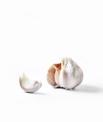 fresh organic garlic isolated over white background, full heads, cloves and peels, cooking ingredients. High quality photo