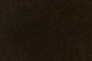 Dark non-uniform paper with spots and inclusions.