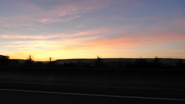 On the road, a sunset while driving between Beaune and Dijon. Burgundy, France.