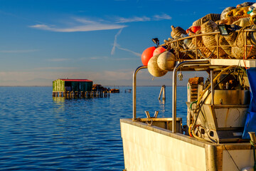 View on the Venetian lagoon with the  fishermen's houses and boat, Pellestrina island, Venetian lagoon, Italy