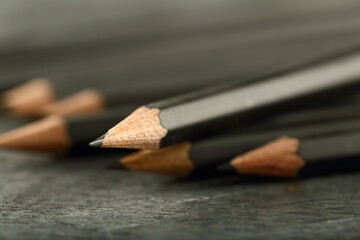 Sharpened black pencils selective focus Image.
