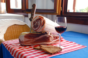 Italian meal with a meat roll and a glass of red wine