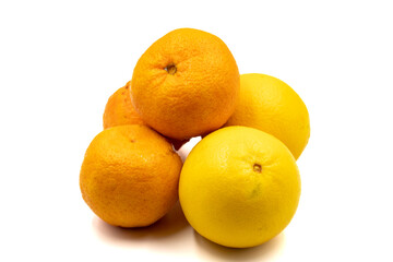 Ripe tangerines and oranges on a white background. Close-up