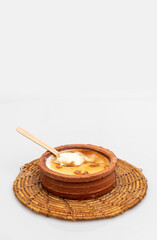 Kithul Jaggary (Caryota urens) on a clay pot of Curd topped with Kithul  treacle