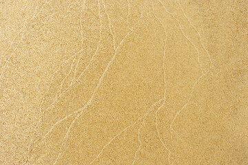 Traces of waves in the sand, texture of the sandy. Patterns and riffles in sand from waves