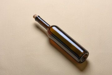 Empty wine bottle isolated on a beige backgrou