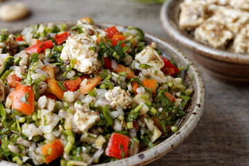 Barley and parsley salad with feta and cashew nuts. Middle Eastern cuisine food.