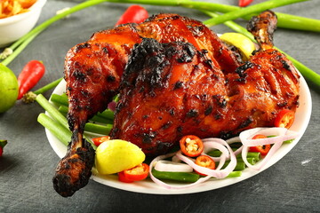 Homemade Indian tandoor cooking- tandoori chicken with vegetable salads.  - obrazy, fototapety, plakaty
