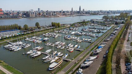 Antwerp yacht club at Linkeroever marina. Boats and yachts with the city of Antwerp in the background. Drone aerial view from above