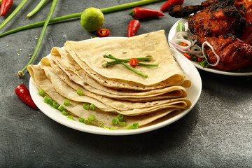 Homemade delicious chapatiis served with spicy grilled chicken. 