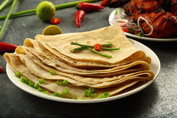 Arabic food cuisine- homemade roti, chapatti, served with tandoori, grilled chicken.
