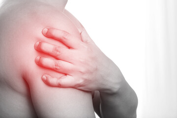 young man touching painful twisted or broken shoulder. Athlete training accident. Sport Exercise is not warm, causing injury. and pain with arm bones. Health care concept.