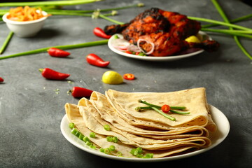 Grilled  tandoori chicken served with fresh made chapattis. Arabic food cuisine.
