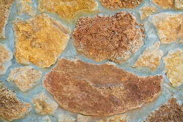 Background of stone wall texture. Yellow stone.