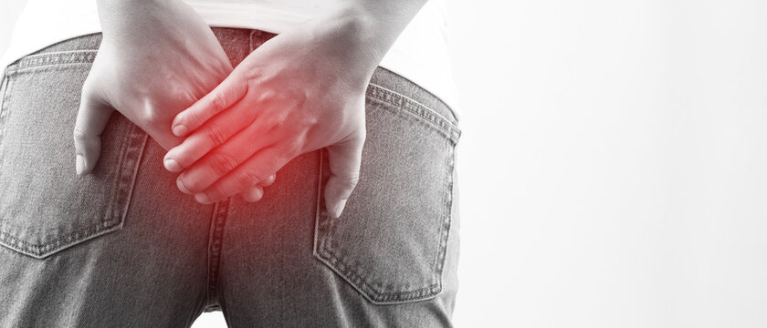 concept of health problems woman has hemorrhoids