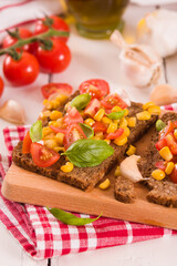 Rye bread withsweet corn, basil and tomato.