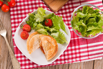 Puff pastry filled with tomato and mozzarella cheese.